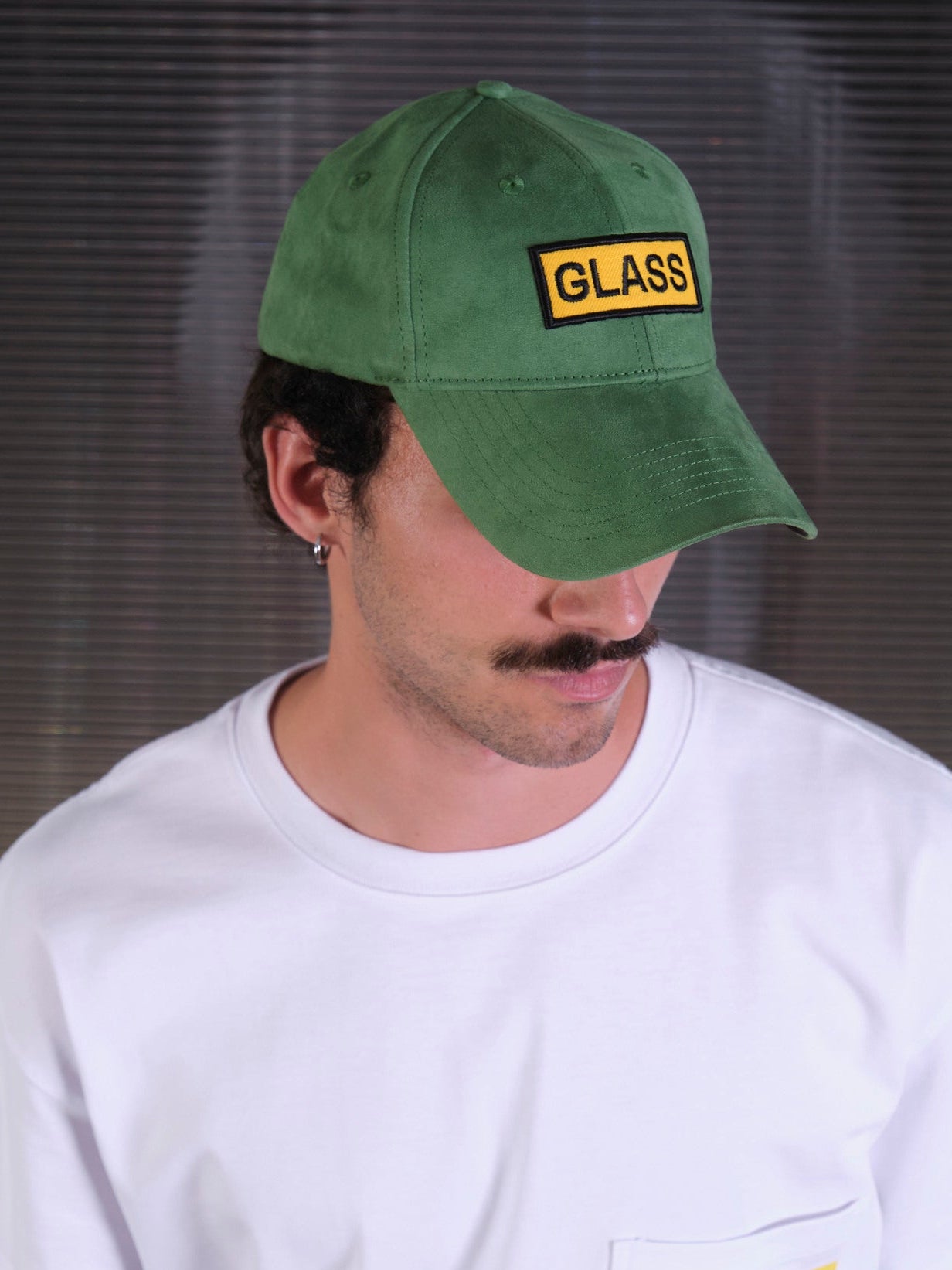 bABP Glass green eco-suede hat from the Signature Collection, portrait view of a model with a mustache wearing a white t-shirt