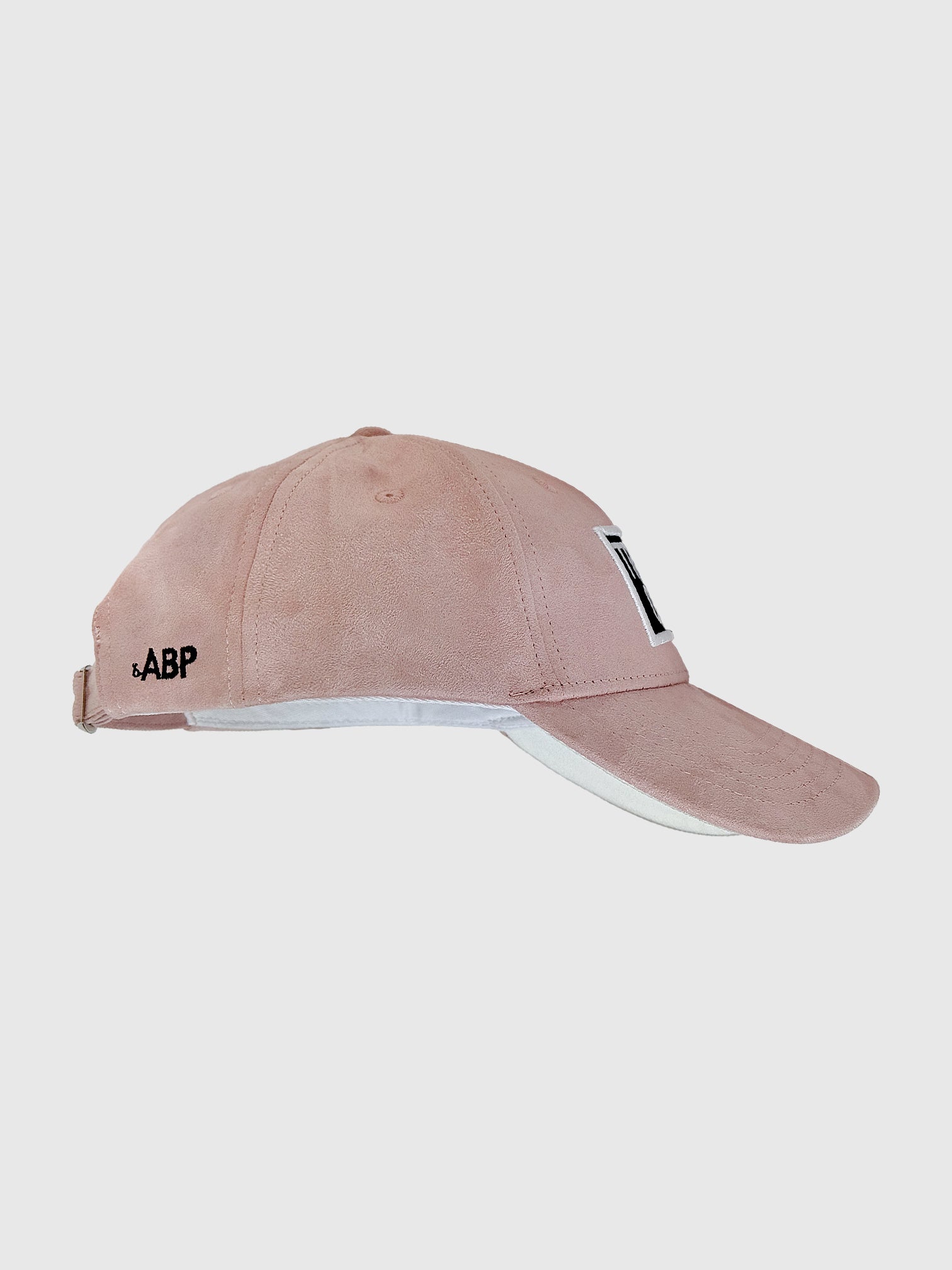 bABP pink eco-suede hat from the Signature Collection, side view on a plain background, showing the adjustable strap and embroidered bABP logo