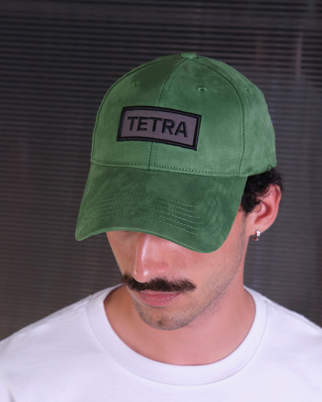 bABP Tetra green eco-suede hat from the Signature Collection, front portrait view on a model with a mustache wearing a white t-shirt