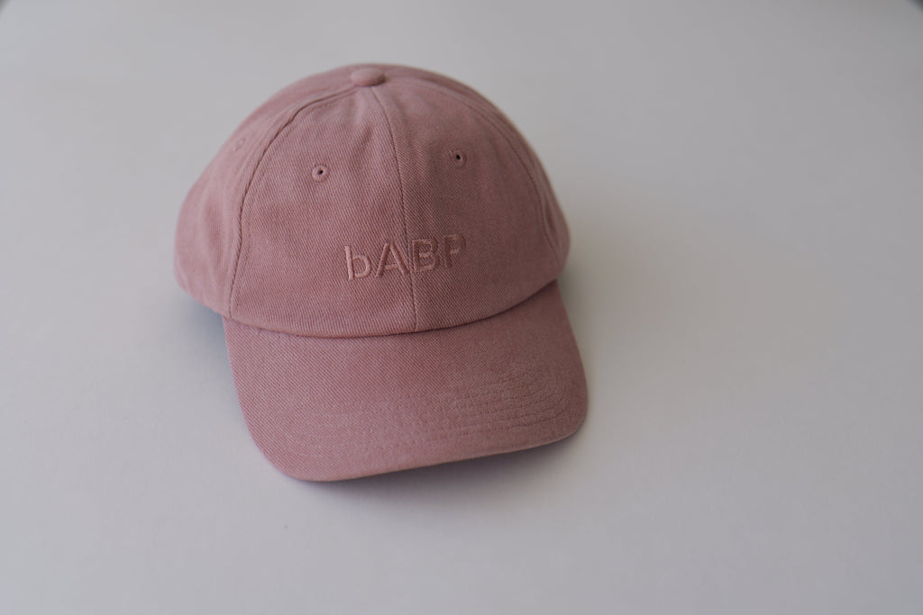 Front view of bABP B-SIDE pink cotton dad hat with tonal logo embroidery, featured on a clean light gray background, premium streetwear style