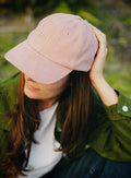 Lifestyle portrait of a person wearing the bABP B-SIDE pink heavy cotton hat, highlighting the "Port of Design: Los Angeles" series aesthetic in an urban setting