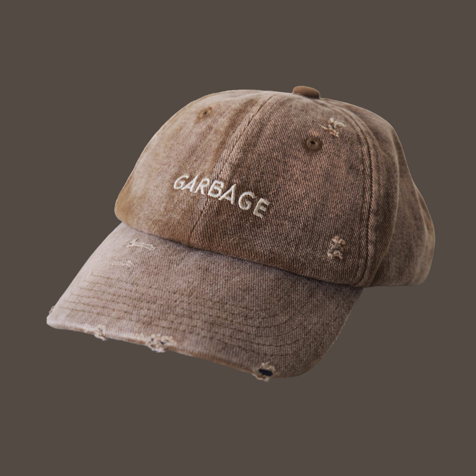 Front view of bABP "GARBAGE" tan distressed cotton hat with tonal embroidery, featuring a vintage washed texture and adjustable fit, B-SIDE collection