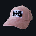 Professional studio shot of bABP "TRASH ONLY" pink eco-suede hat with a black and white embroidered logo patch, featured on a matching monochromatic black background